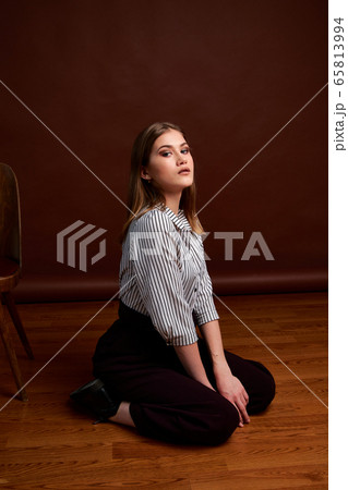 Gorgeous young female in classic suit, black shoes 65813994