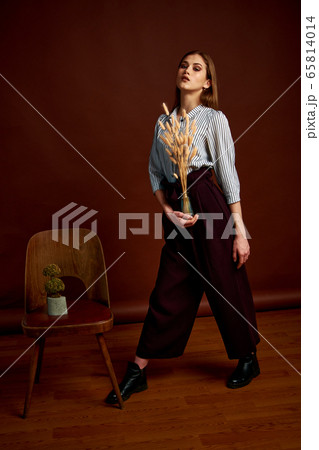 Gorgeous young female in classic suit, black shoes 65814014