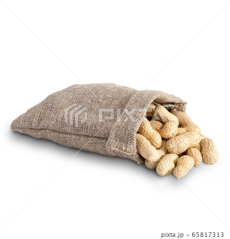 Unpeeled peanuts closeup in a burlap bag on a white background. Isolated 65817313
