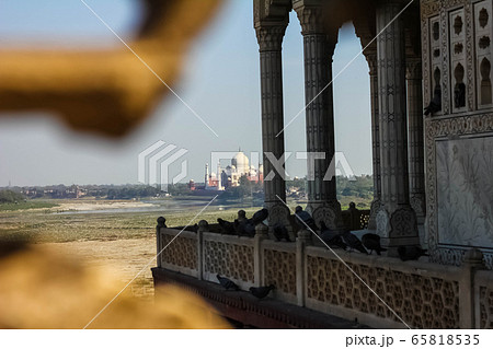 View of Taj Mahal from lattice jali in Agra, Uttar Pradesh, India. It was build by shah jahan as a memorial for his second wife Mumtaz Mahal 65818535
