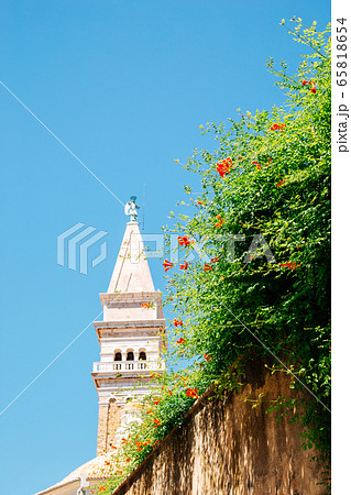 St. George's Parish Church tower with flowers in Piran, Slovenia St. George's Parish Church tower with flowers in Piran, Slovenia 65818654