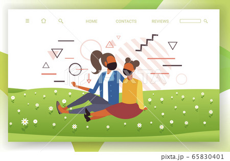 girls sitting on grass women wearing medical masks to prevent coronavirus pandemic quarantine concept 65830401