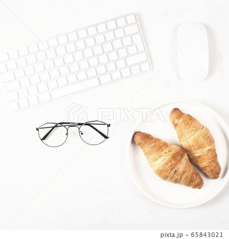 Croissants in a bright workplace as a snack during Croissants in a bright workplace as a snack during 65843021