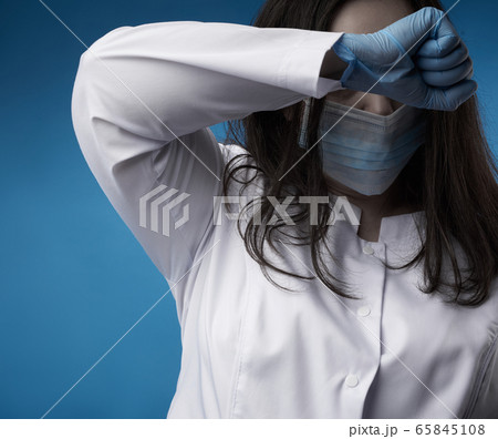 young woman doctor in a white coat, blue latex 65845108