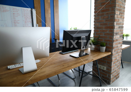 Empty office background with pc monitor closeup Empty office background with pc monitor closeup 65847599