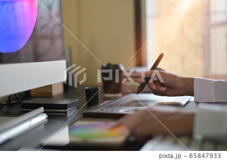 Graphic designer working with digital pen and tablet with computer. Graphic designer working with digital pen and tablet with computer. 65847933