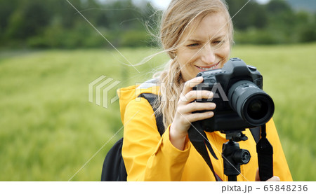 Woman looking through latest images Woman looking through latest images 65848236