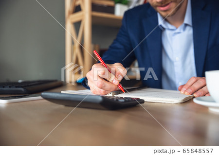 Young man, manager, team led return to work in his office after quarantine, feels happy and inspired Young man, manager, team led return to work in his office after quarantine, feels happy and inspired 65848557