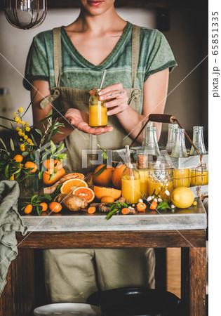 Young woman holding bottle of fruit vitamin 65851335
