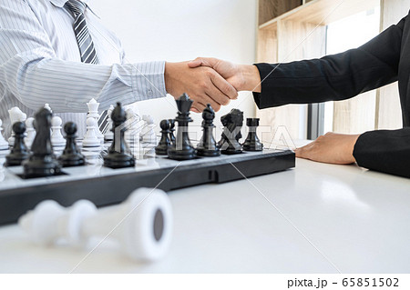 Businessman and businesswoman shaking hands after 65851502