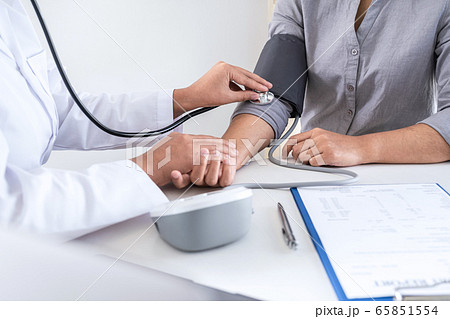 Doctor using a measuring blood pressure checking 65851554
