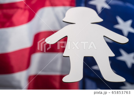 Large paper person shape on mirror background with American flag reflected in it. 4th of july background photos concept 65853763