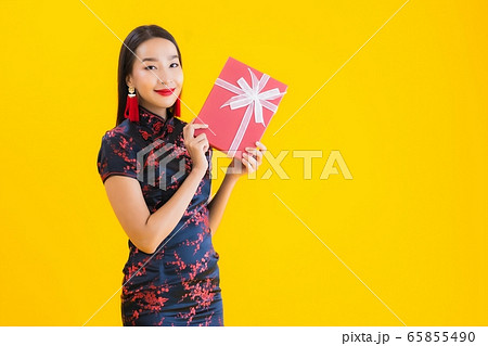 Portrait beautiful young asian woman wear chinese dress with red gift box Portrait beautiful young asian woman wear chinese dress with red gift box 65855490