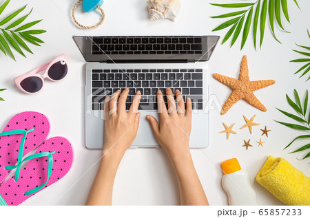 Working vacation them with laptop and beach items 65857233