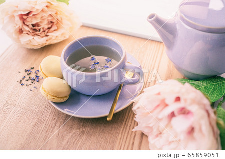Tea cup home serving for one english black tea black tea with teapot and macarons cookies with lovely pink peonies flowers decoration Tea cup home serving for one english black tea black tea with teapot and macarons cookies with lovely pink peonies flowers decoration 65859051