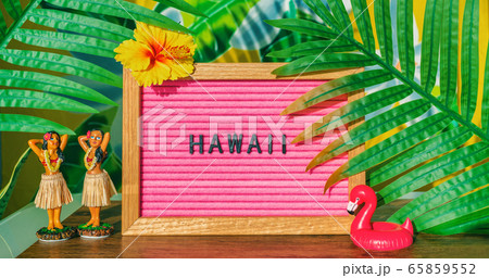 Hawaii travel retro sign with hula dancing dolls pink flamingo toy float and plastic palm tree leaves for kitsch board. Hawaiian vacation summer holidays background Hawaii travel retro sign with hula dancing dolls pink flamingo toy float and plastic palm tree leaves for kitsch board. Hawaiian vacation summer holidays background 65859552