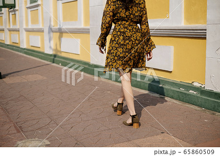 Girl walking on sidewalk. Girl walking on sidewalk. 65860509