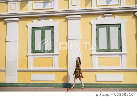 Thai woman walking on sidewalk. Thai woman walking on sidewalk. 65860510