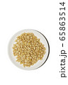 Organic food. Pine nuts on a white background. Cedar nuts flatlay on a white saucer. Agricultural concept. Superfood, top view, copy space. Banner vertical format with empty space for your text 65863514
