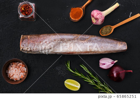 Hake with spice on black background 65865251