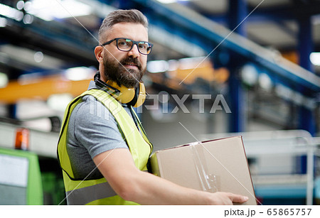Man worker working in industrial factory or warehouse. 65865757