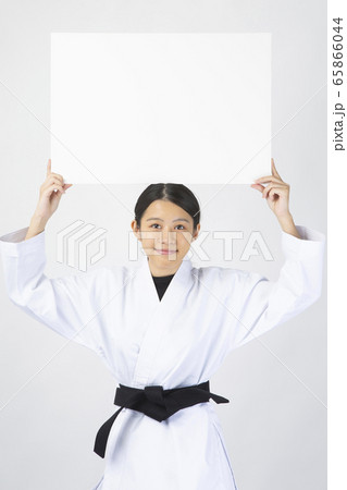 ホワイトボードを手に微笑む女性空手家 65866044