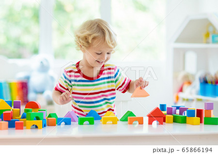 Kids toys. Child building tower of toy blocks. 65866194