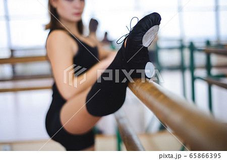 Dancer is doing exercises in ballet class 65866395