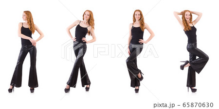 Redhead woman in black bell bottom pants on white 65870630