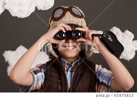 a boy plays with binoculars and dreams of becoming a boy plays with binoculars and dreams of becoming 65870813