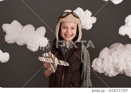 a girl plays with a cardboard airplane and dreams 65871797