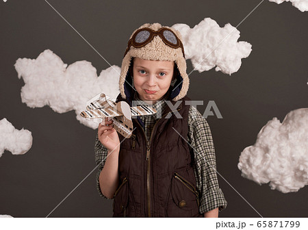 a girl plays with a cardboard airplane and dreams a girl plays with a cardboard airplane and dreams 65871799
