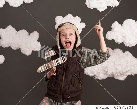 a girl plays with a cardboard airplane and dreams 65871801