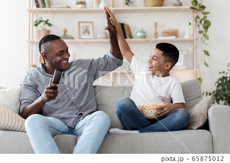 Black Boy And His Happy Grandpa Giving High Five To Each Other 65875012