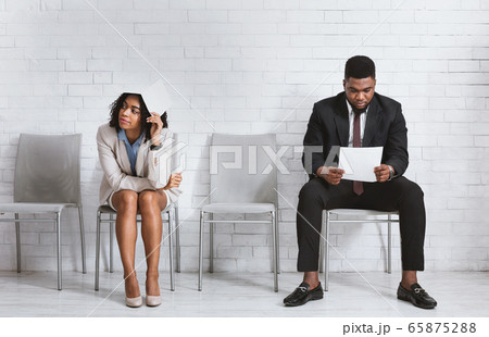 Exhausted vacancy applicants waiting for job interview at corporate office Exhausted vacancy applicants waiting for job interview at corporate office 65875288