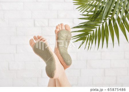 Beauty care in spa. Foot care with clay on white brick wall Beauty care in spa. Foot care with clay on white brick wall 65875486