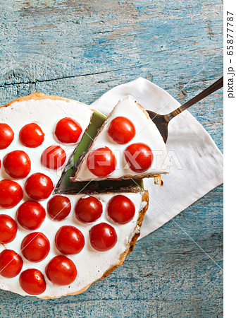 zucchini cake with tomato and parsley on a blue wooden 65877787