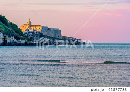 south italy background of Vieste church village at sunset by the sea with purple sky 65877788