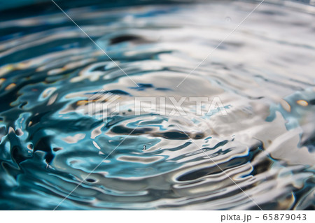 Water splash close-up. Drop of water. Blue water drop. Falling water. blue water surface with splash and air bubbles. Water splash close-up. Drop of water. Blue water drop. Falling water. blue water surface with splash and air bubbles. 65879043