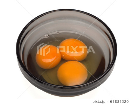 three egg yolks in cup three egg yolks in cup 65882320