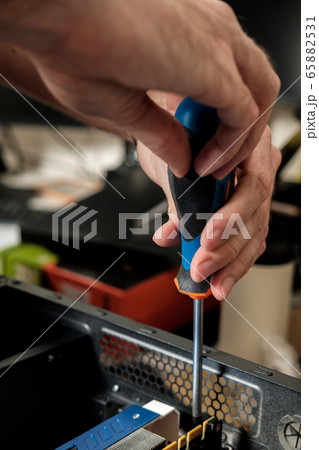 Man repairs a computer system unit, changes parts, video card and hard drive. Computer Repair Wizard. 65882531