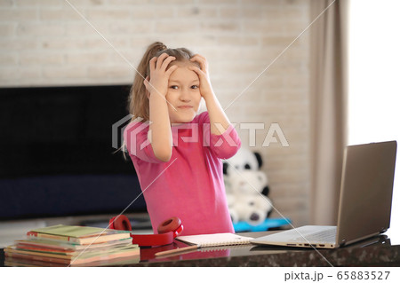 Emotional portrait of schoolgirl studying homework, home schooler  65883527