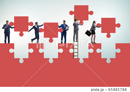 Businessman in teamwork concept with jigsaw puzzle 65885788