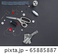sewing items on a black background from above 65885887
