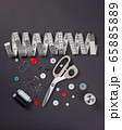 sewing items on a black background from above 65885889