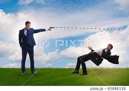 Businessman with gun threatening his competitor 65886136