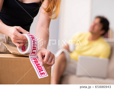 Young pair moving to new flat with fragile things 65886943
