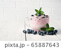 Yogurt with cream and berries on a white background. 65887643