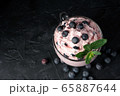 Cottage cheese dessert with cream and berries on a black background. 65887644