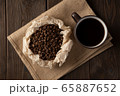 Coffee Cup and coffee beans in a paper saucer 65887652